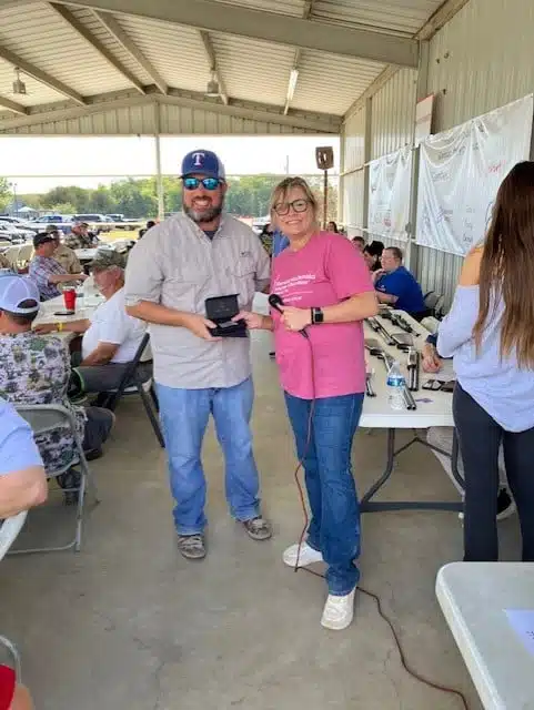 A participant receiving an award from Shannon Gowan Dean at the Sporting Clay Shoot benefiting the Ronald McDonald House of Temple
