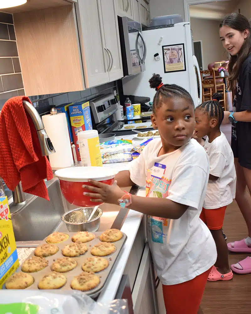 Two girl volunteers make cookies at the Ronald McDonald House of Temple